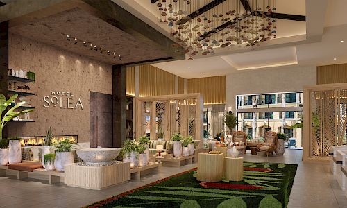 A stylish hotel lobby with modern decor, plants, seating areas, and a reception desk; sign reads &ldquo;SOLEA.&rdquo; Napoli-style elegance in a bright space.